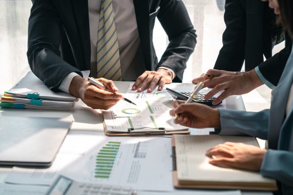economic concepts business and partner plan data analysis to determine the direction of the company's business investment in the workplace. night marketing consultant concept