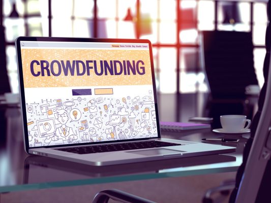 crowdfunding concept on laptop screen.