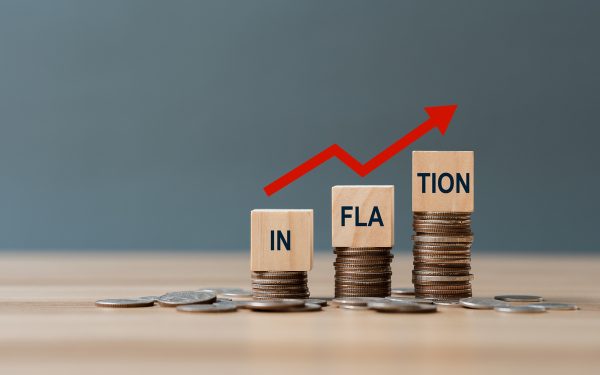 inflation word on a wooden cube on coins in idea for fed conside