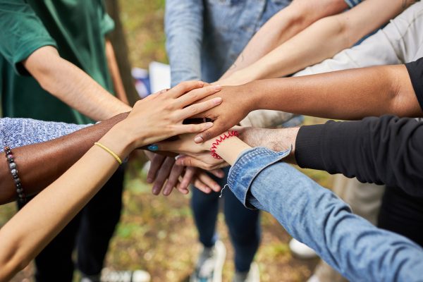 close up photo of diverse people's hands gathered together