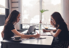 woman working with laptop,teamwork business brainstorm,business cooperation working on desk,tutor revise and learning education,enjoy working and brainstorming on cafe,vintage tone and selective focus