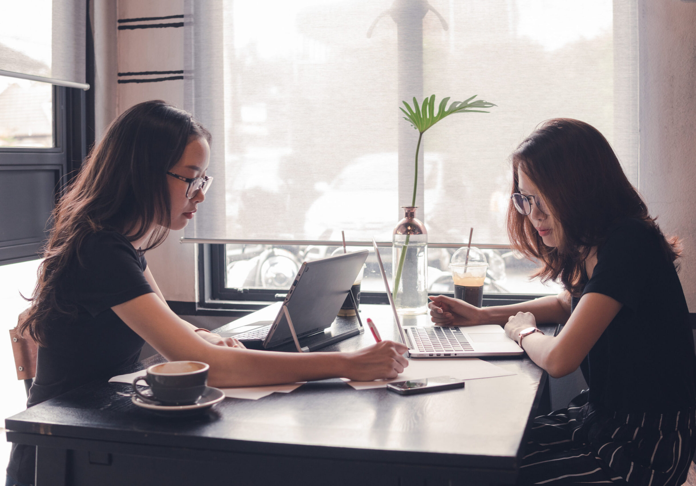 woman working with laptop,teamwork business brainstorm,business cooperation working on desk,tutor revise and learning education,enjoy working and brainstorming on cafe,vintage tone and selective focus