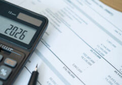 close up of black calculator screen showing 2026 with detailed financial reports underneath. this composition highlights data analysis and preparation for upcoming financial decisions.