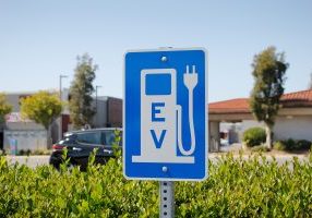 a view of a city sign and symbol for electric vehicle parking an
