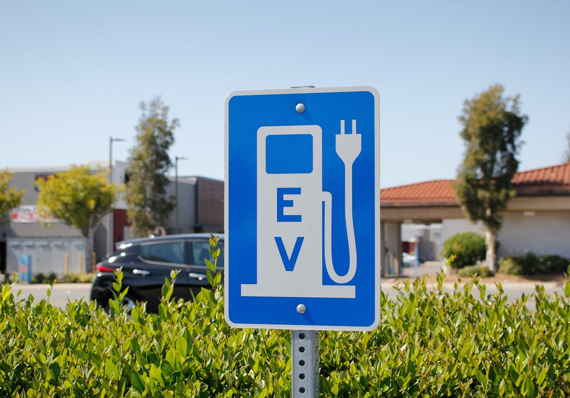 a view of a city sign and symbol for electric vehicle parking an