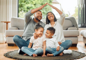 family, parents and children with roof, safety and protection with love, care and security with happiness at home. hands together, insurance cover or people in house with mom, dad and kids with trust