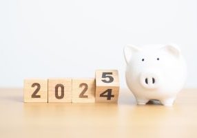 2024 end year to happy new year 2025 with piggy bank. resolution, goals, plan, action, money saving, retirement fund, pension, investment and financial concept