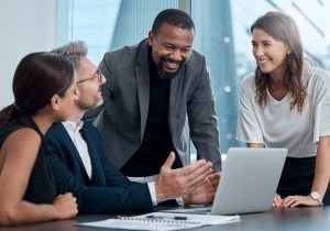 working on a master plan. cropped shot of a group of corporate business colleagues having a meeting around the table in the boardroom.